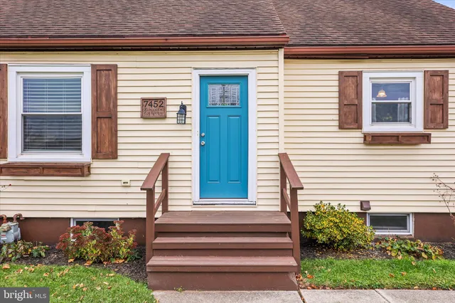 a front view of a house with plants and garden