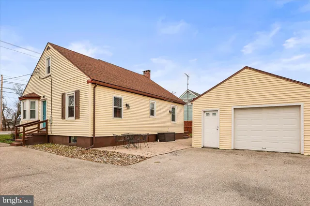 a view of a white house with a yard