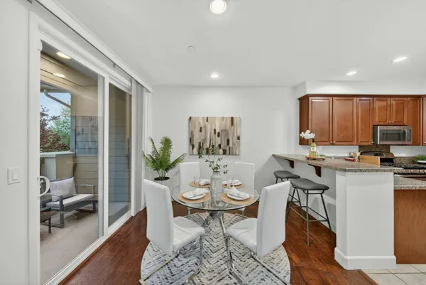 a view of a dining room with furniture window and wooden floor