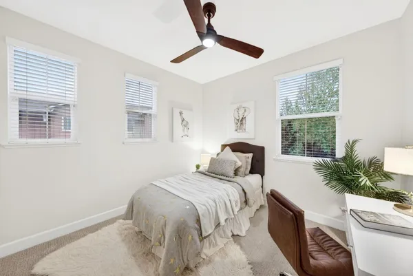 a bedroom with a large bed and a window