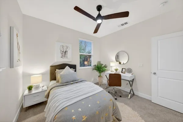 a bedroom with a bed a desk and chair