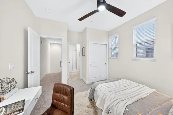 a bedroom with a bed couch and window