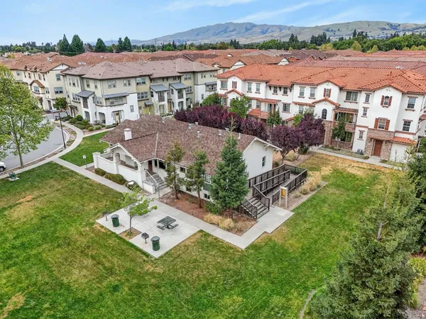 an aerial view of residential house with outdoor space and seating