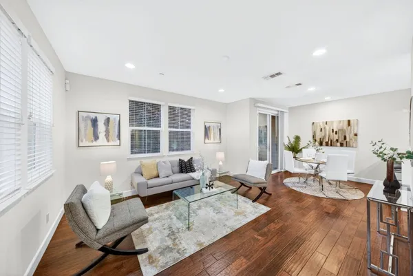a living room with furniture and wooden floor