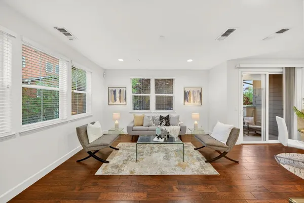a living room with furniture rug and window