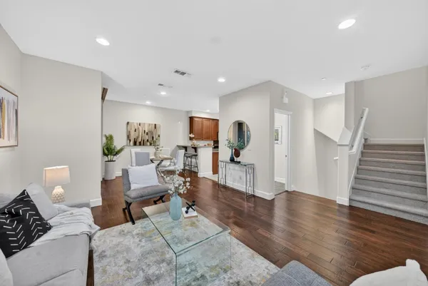 a living room with furniture and wooden floor