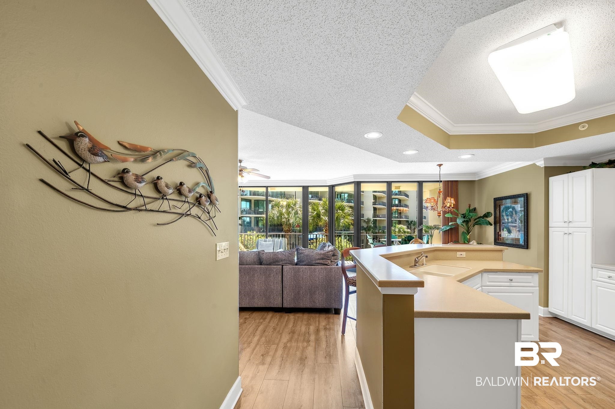 27580 Canal Road, Unit 1214 AND BOAT SLIP #62 Orange Beach, AL 36561 - Photo 66 of 67 Kitchen with open floor plan, crown molding, white cabinets, and light wood-type flooring