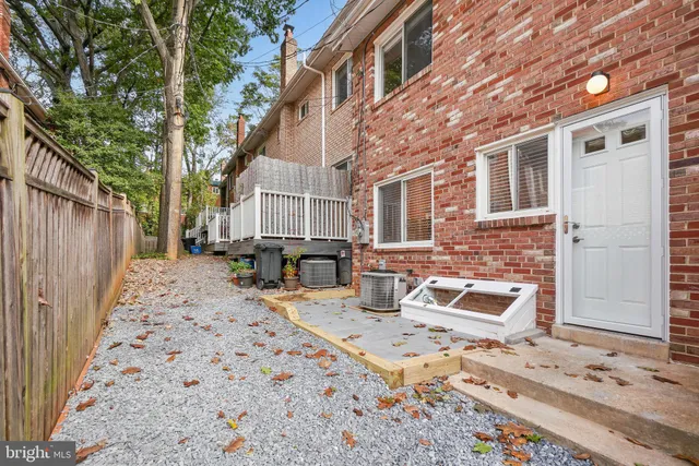 a view of a backyard with table and chairs with wooden fence and plants