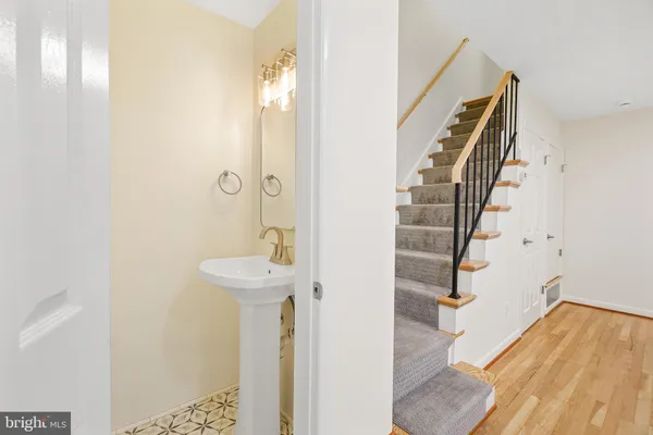 a view of a hallway with wooden floor and entryway