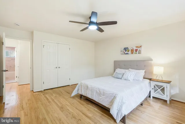 a bedroom with a bed and a ceiling fan