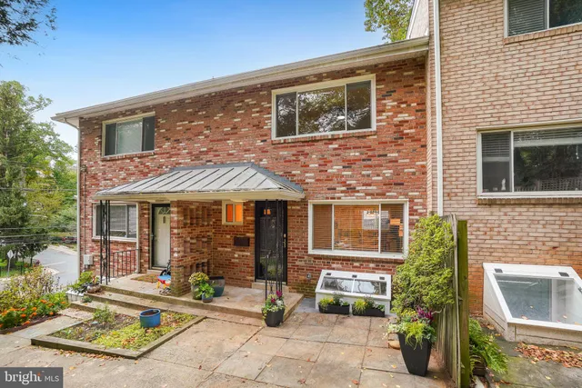 a front view of a house with outdoor seating