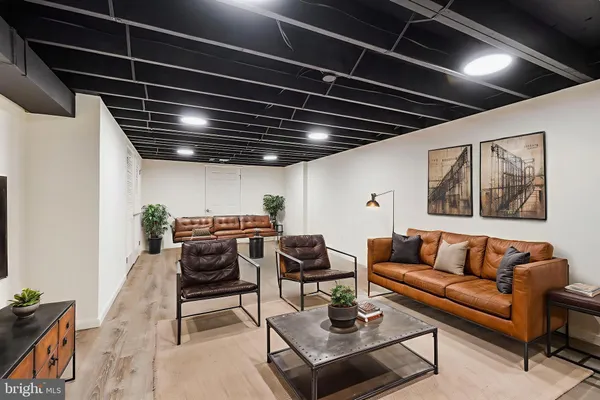 a living room with furniture and wooden floor