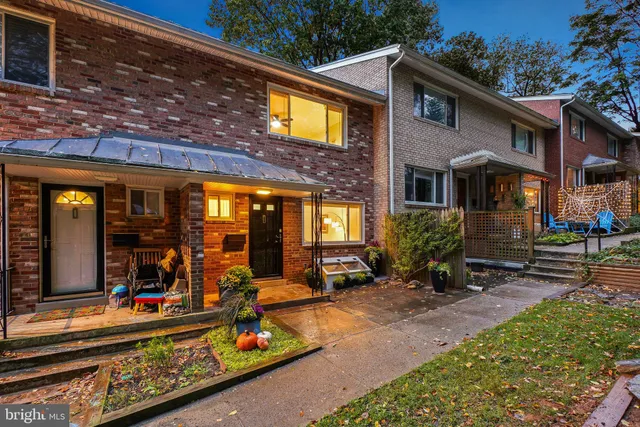 a view of a house with large windows and plants