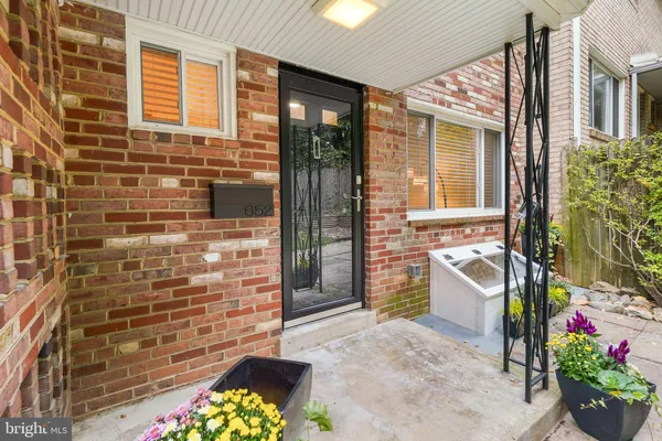a front view of a house with an outdoor space and seating