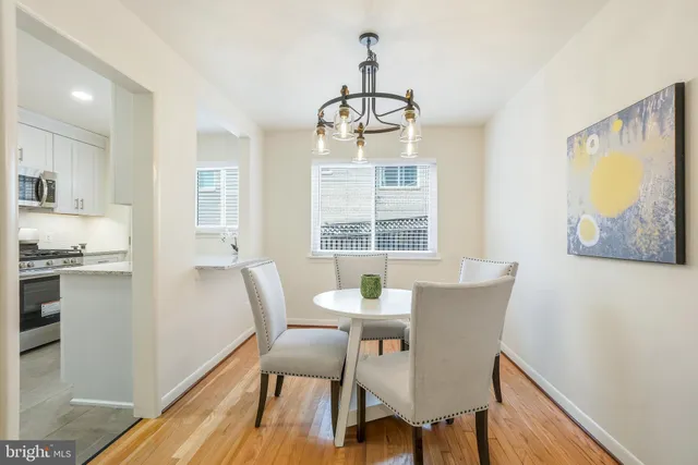 a view of a dining room with furniture wooden floor and a chandelier