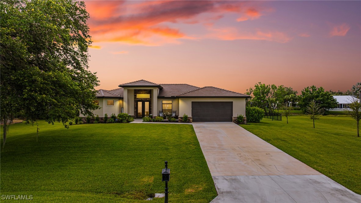 a front view of a house with garden