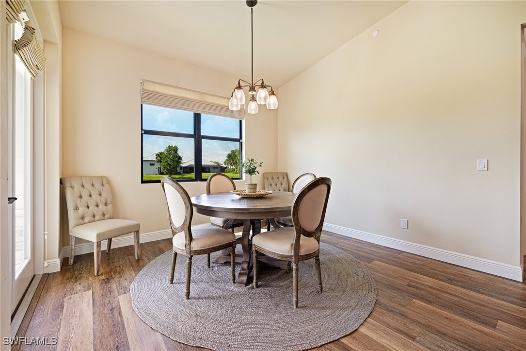 16630 Willow Point Court Alva, FL 33920 - Photo 17 of 46 a dining room with furniture a rug and a chandelier