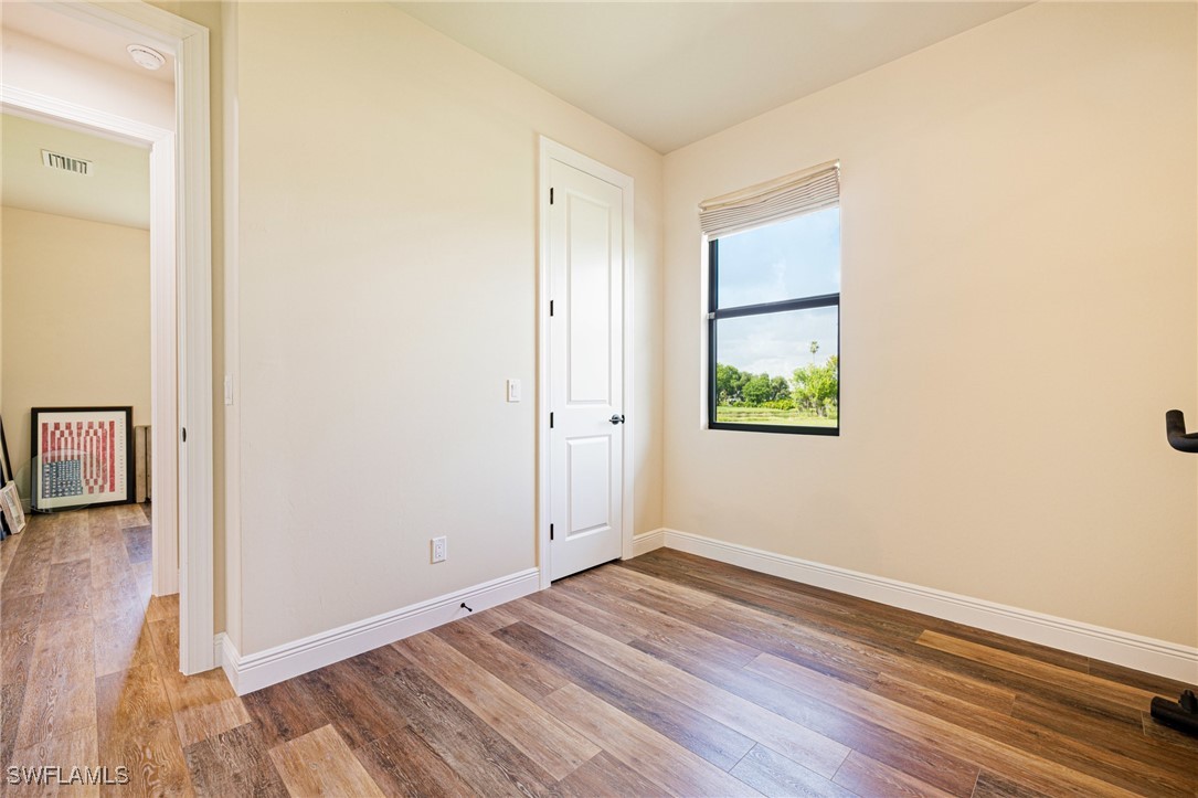 16630 Willow Point Court Alva, FL 33920 - Photo 31 of 46 an empty room with wooden floor and windows