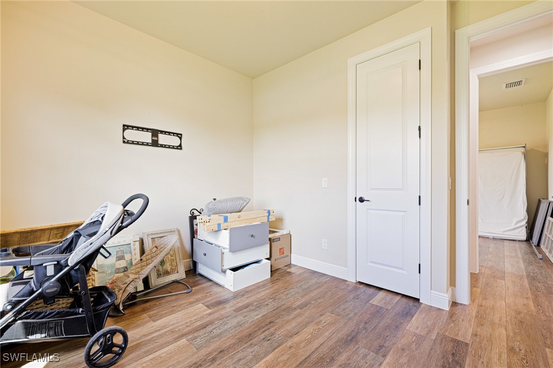 16630 Willow Point Court Alva, FL 33920 - Photo 33 of 46 a view of a room with wooden floor and white walls