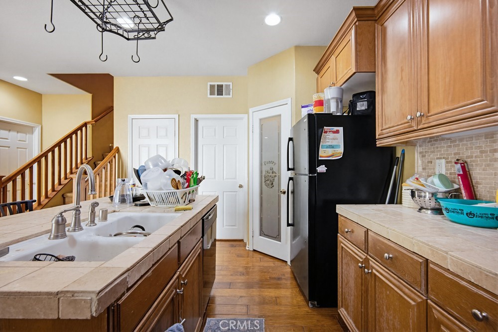 1747 Palermo Drive Riverside, CA 92507 - Photo 12 of 30 a kitchen with stainless steel appliances a sink stove and refrigerator