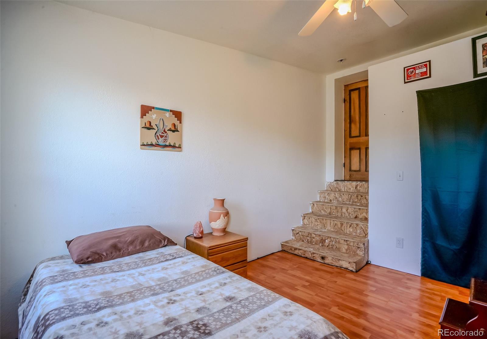 640 P County Road 571 Gardner, CO 81040 - Photo 32 of 47 a bedroom with bed and wooden floor
