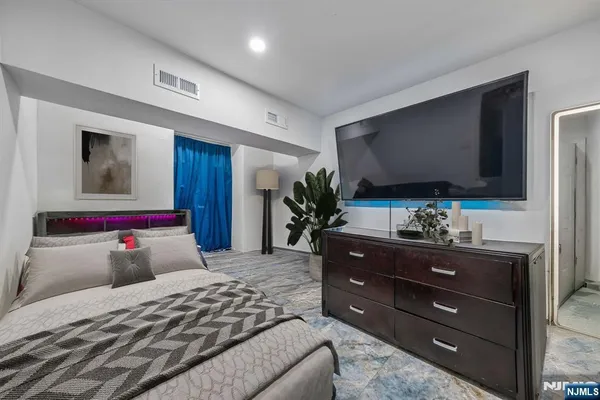 a bedroom with a bed and a flat screen tv