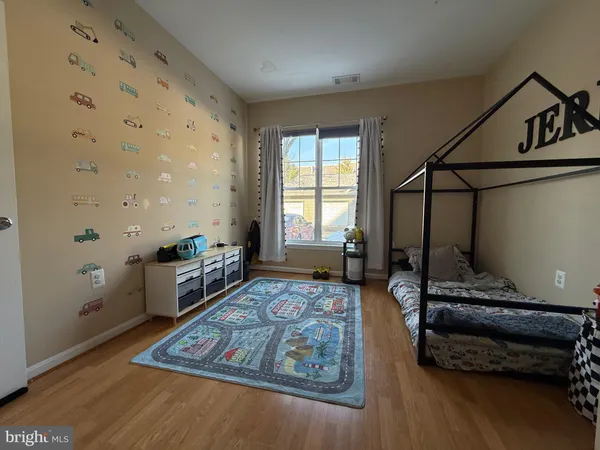 a bedroom with furniture and a window