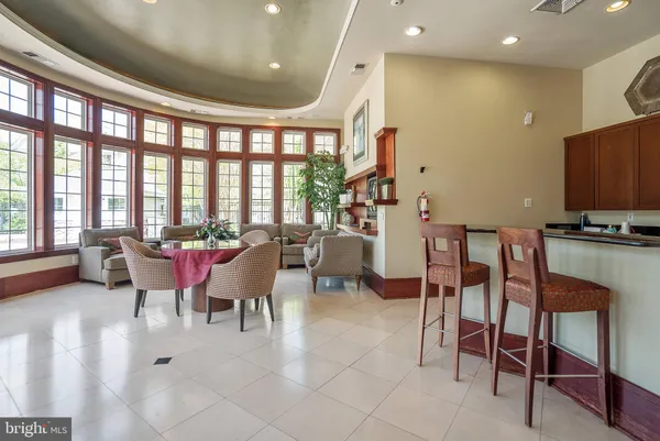 a living room with fireplace furniture and a large window