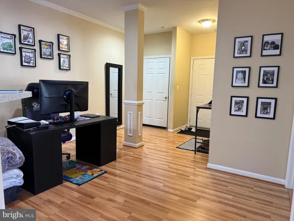 a view of a workspace with furniture and a flat screen tv