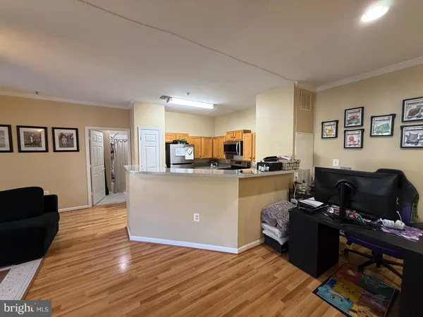 a living room with furniture and kitchen view
