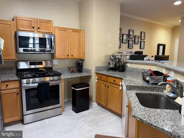 a kitchen with a sink stove top oven and microwave