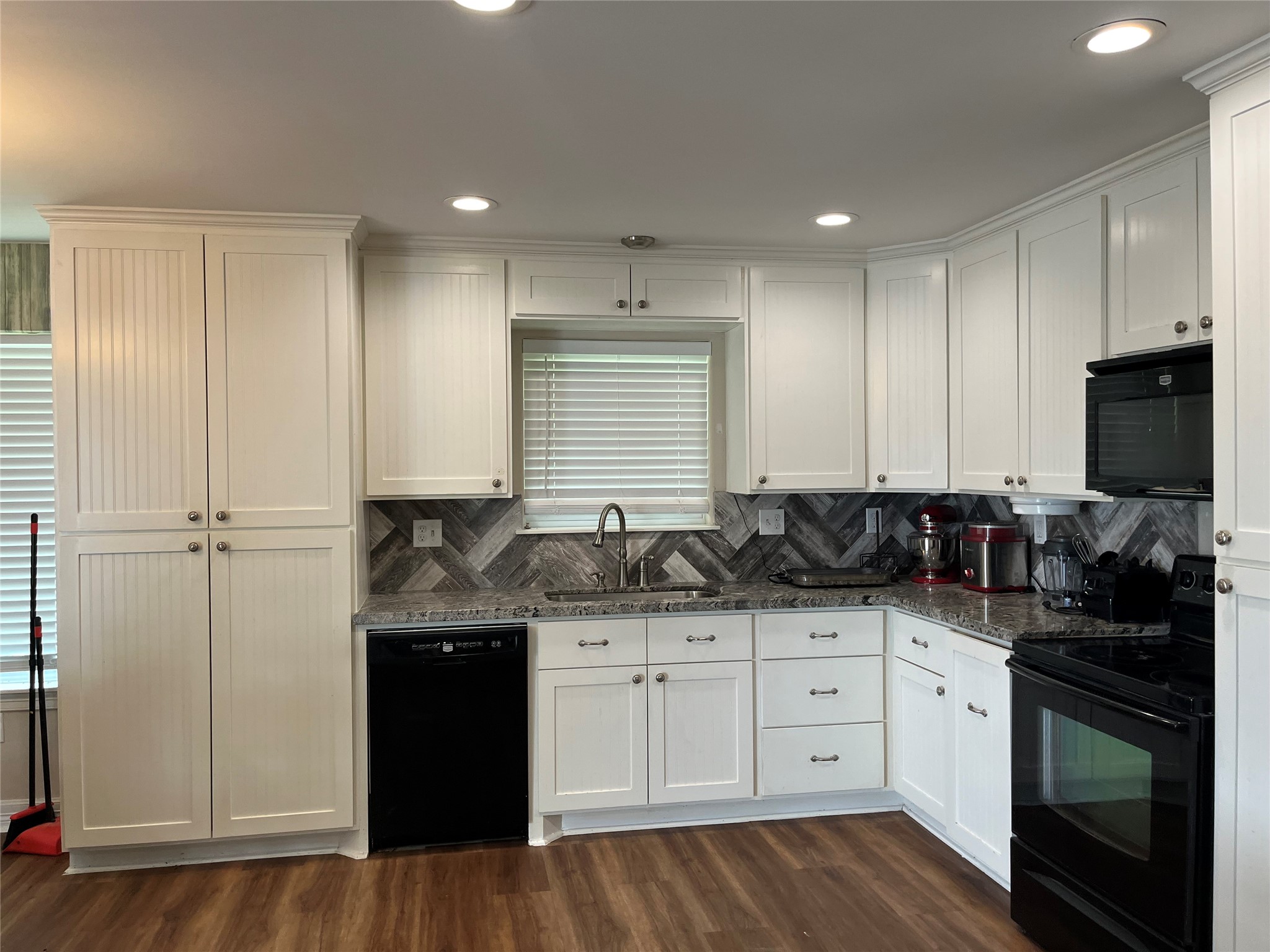 21511 Rio Villa Drive Houston, TX 77049 - Photo 26 of 45 a kitchen with a sink stove and cabinets