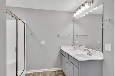 a bathroom with a sink a mirror and a shower