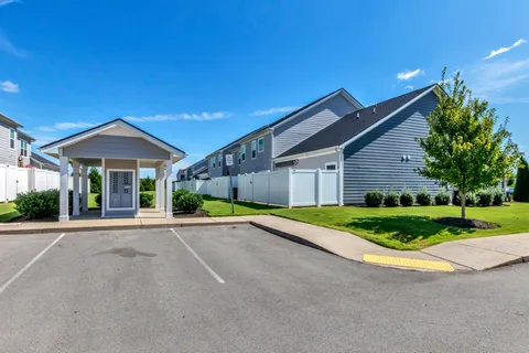 a patio with a table and chairs under an umbrella