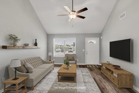 a living room with furniture and a flat screen tv