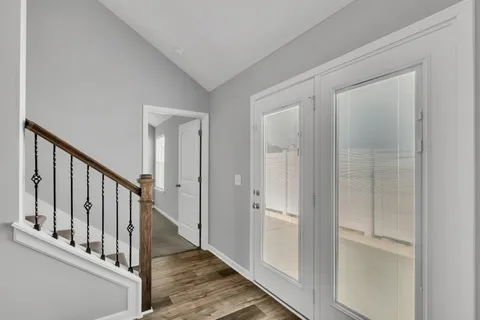 a view of an entryway with wooden floor