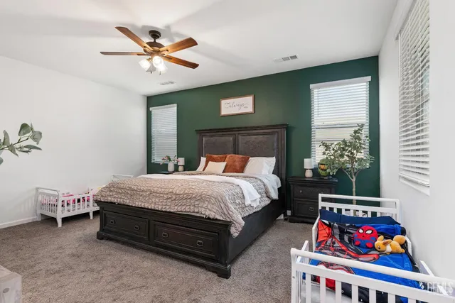 a bedroom with a bed and a chandelier