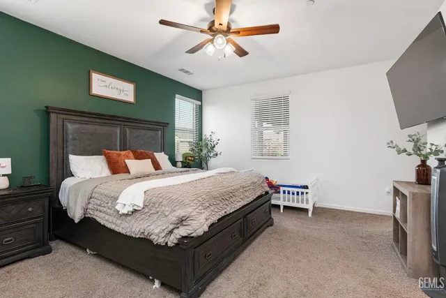 a bed sitting in a bedroom chandelier and a tv