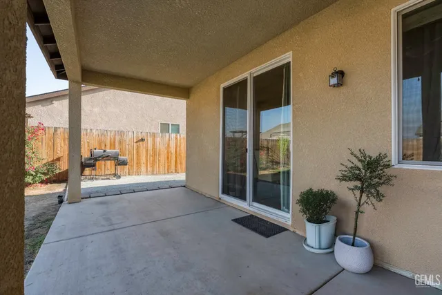 a living room with furniture and potted plants