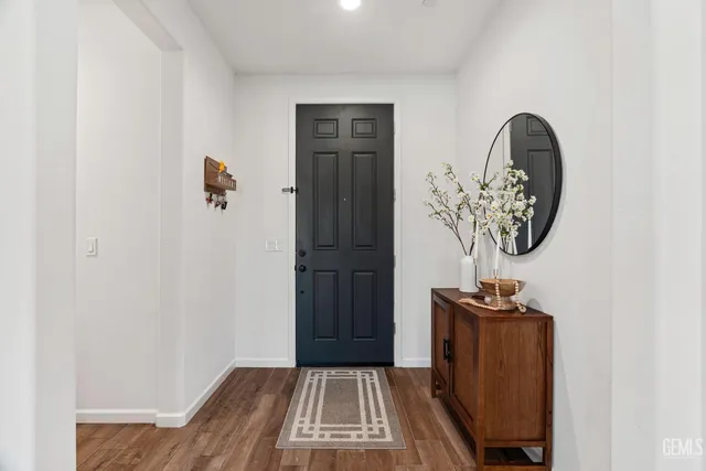 a view of a entryway door with wooden floor