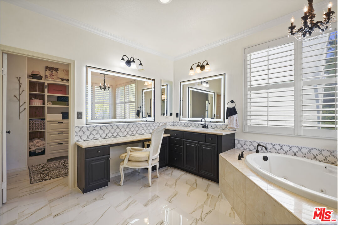23871 Rio Ranch Way Valencia, CA 91354 - Photo 16 of 46 a spacious bathroom with a tub sink and mirror