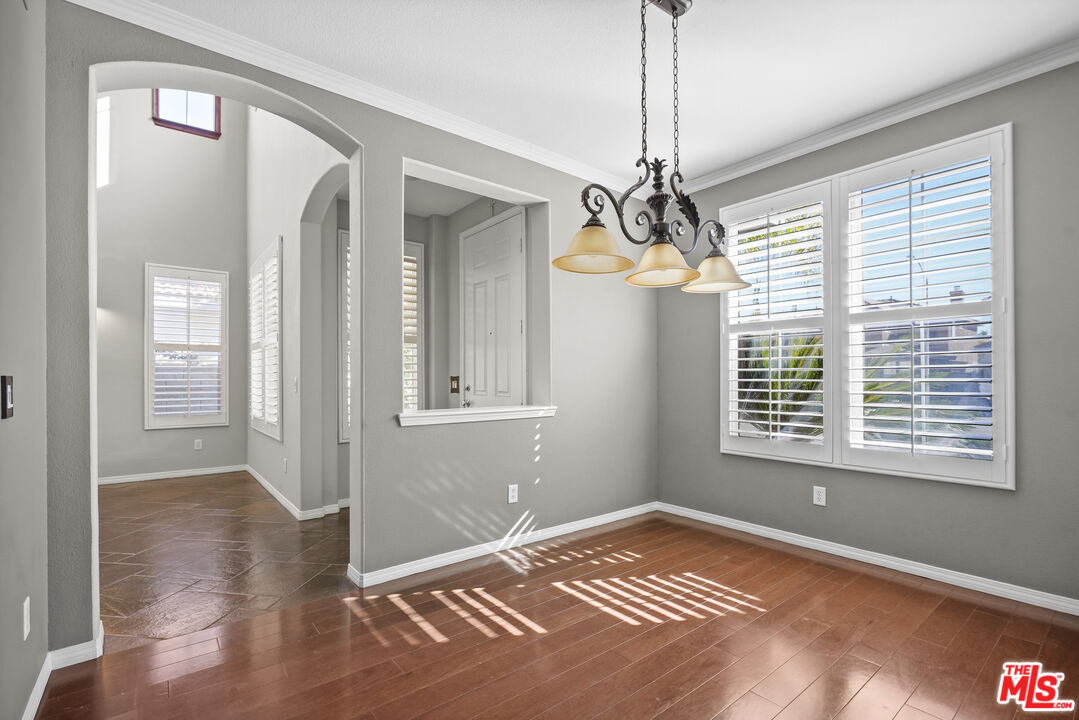 23871 Rio Ranch Way Valencia, CA 91354 - Photo 19 of 46 a view of an empty room with window and chandelier fan