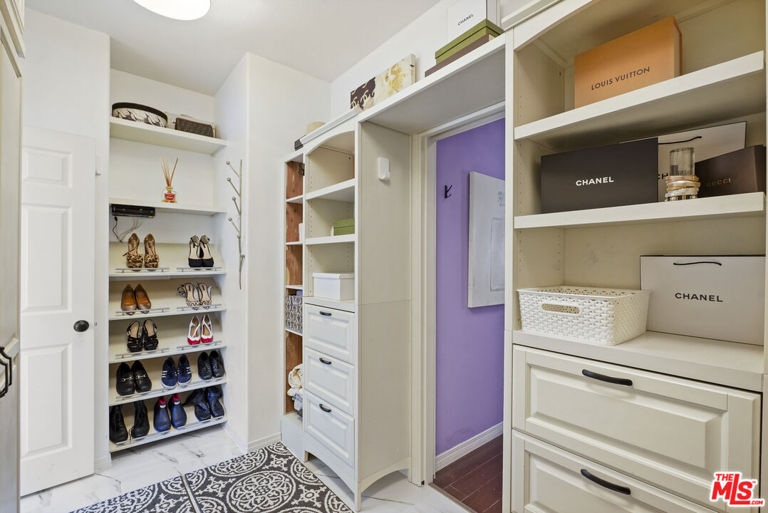23871 Rio Ranch Way Valencia, CA 91354 - Photo 22 of 46 a kitchen with white cabinets and a window