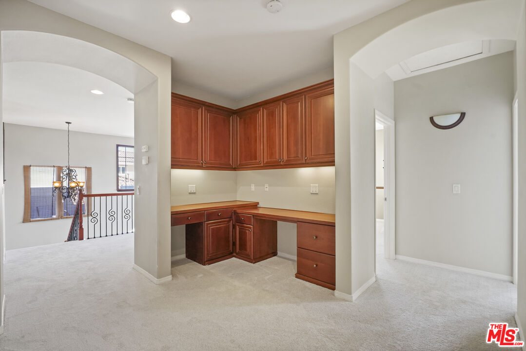 23871 Rio Ranch Way Valencia, CA 91354 - Photo 26 of 46 a kitchen with stainless steel appliances granite countertop a refrigerator and a sink