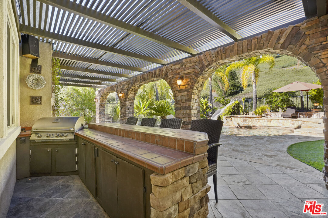 23871 Rio Ranch Way Valencia, CA 91354 - Photo 30 of 46 a kitchen with a sink and a stove