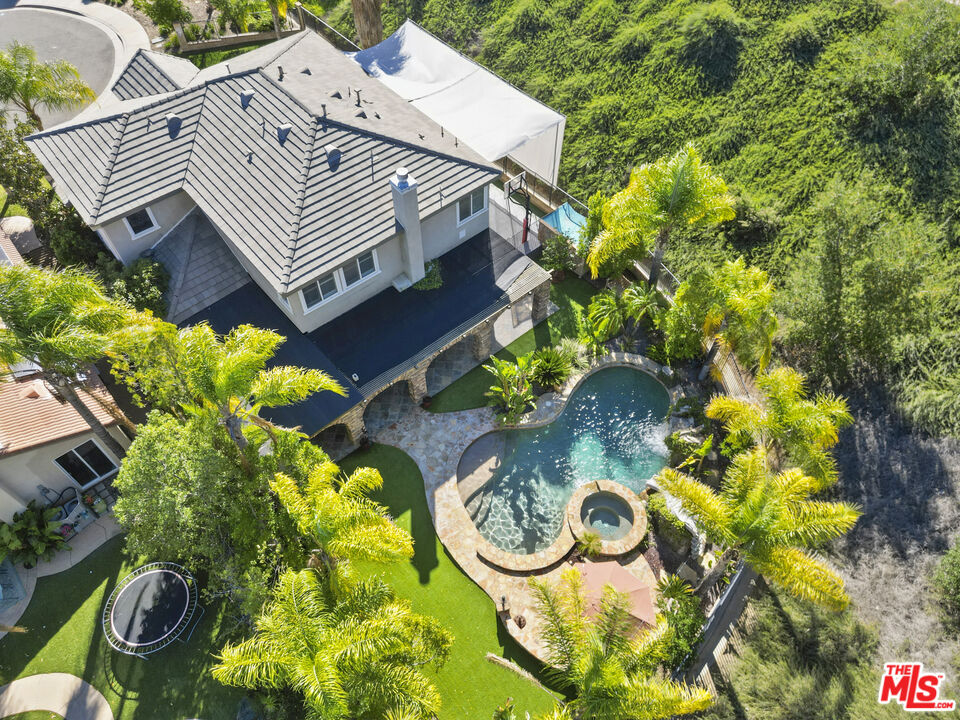 23871 Rio Ranch Way Valencia, CA 91354 - Photo 37 of 46 a view of a house with swimming pool and a yard