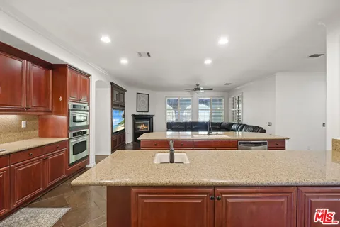 a kitchen with stainless steel appliances granite countertop a sink and cabinets