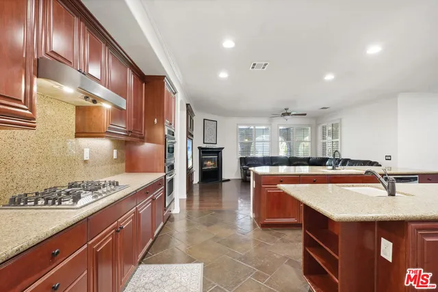 a kitchen with stainless steel appliances granite countertop a sink and stove