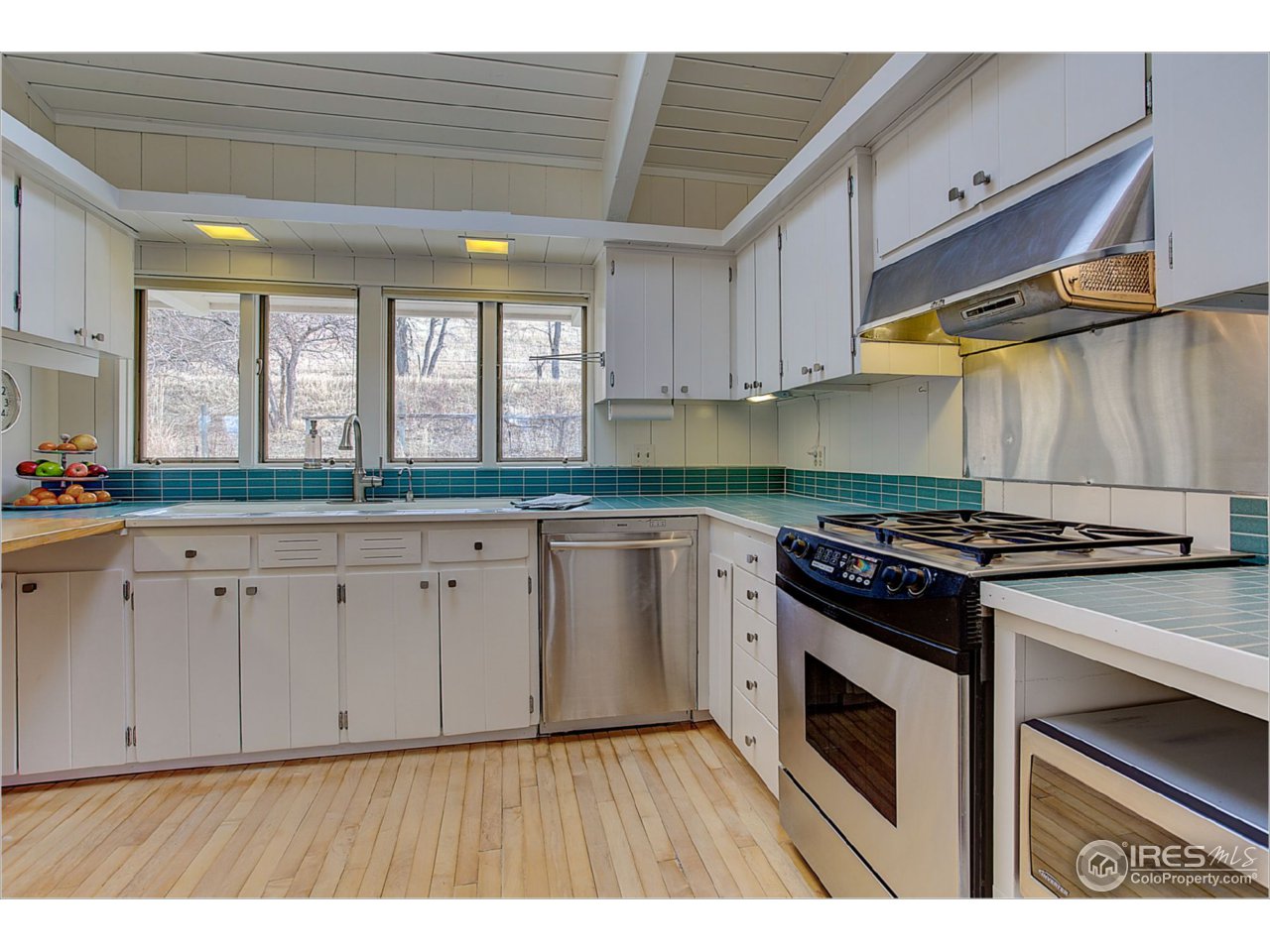 1498 Marshall Road Boulder, CO 80305 - Photo 18 of 40 a kitchen with granite countertop a stove sink and cabinets