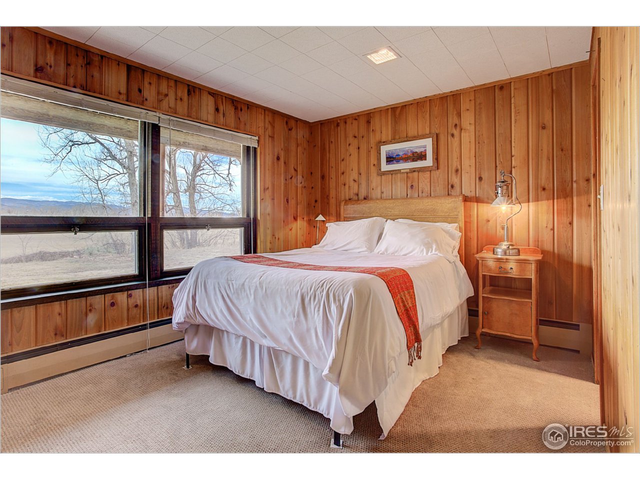 1498 Marshall Road Boulder, CO 80305 - Photo 22 of 40 a bed room with a bed and a large window